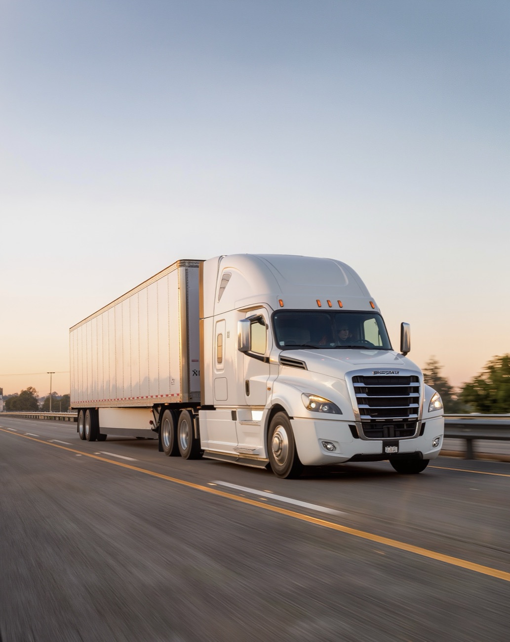 Driver behind the wheel of a Ryan Logistics truck